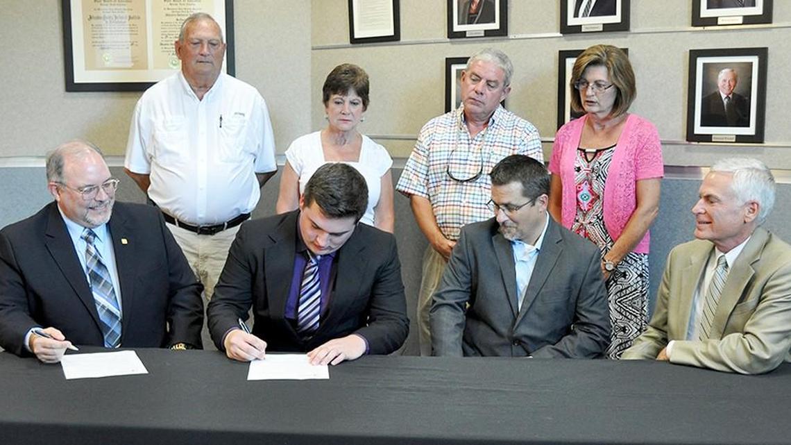 Cody Worley of Willow Spring, second from left, signs his internship agreement with Novo Nordisk. With him are, from left: seated – Stephen Miller, manager of talent and acquisition for Novo Nordisk; Joe Hill, manager of facilities, maintenance and engineering at Novo; and Dr. David Johnson, JCC president; and back row – Charles and Faye Barwick, Cody’s grandparents; and Amos and Karen Worley, Cody’s parents.