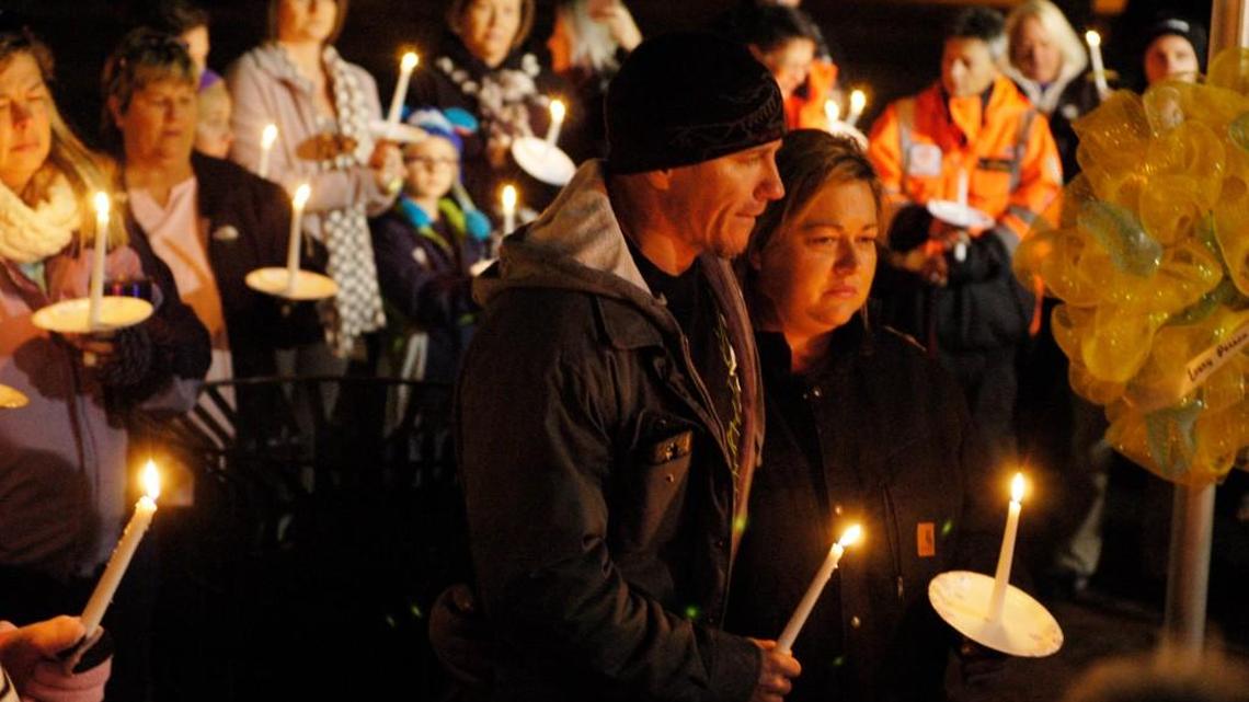 Christopher and Kathy Thomas stand in the middle of a candlelight vigil held in Benson this week for their missing son, Cole Thomas.
