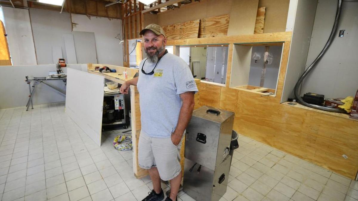 Jerry Stephenson poses amidst the construction of what will be Redneck Barbeque Labs at McGee’s Crossroads.