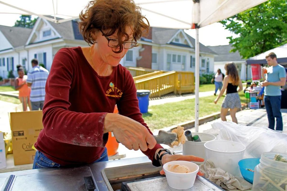 Amy Nakhle of Smitty’s Homemade Ice Cream scoops sweet potato souffle ice cream at the 2016 Smithfield Ham & Yam Festival.