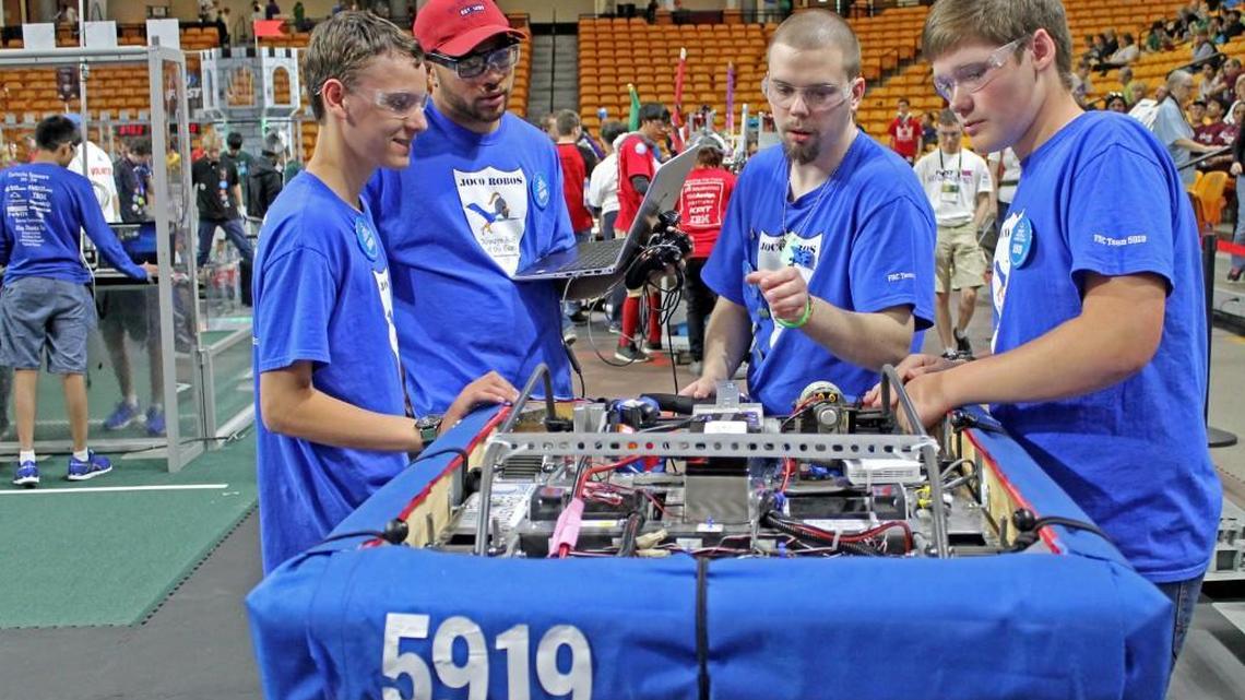 From left, Karsh Agbayani, Reginald Harper, Adrian Wierzbinski and Ethan Smith prepare robot CODI for its next phase of competition at Campbell University on April 2.