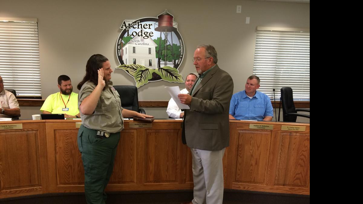 
Archer Lodge Mayor Mike Gordon, right, swears in Clayton animal-control officer Angela Lee. 

