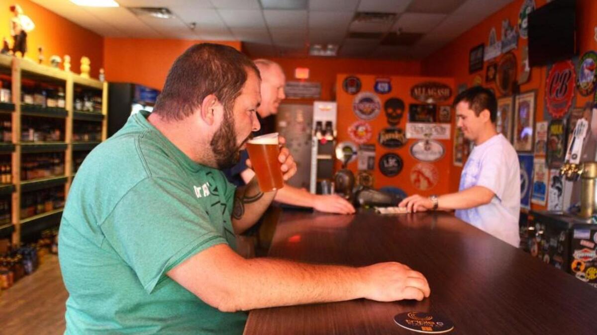 David Alvord sips on a beer at Clayton Beverage Co., one of a handful of beer-centric spots to open in Clayton in the last few years. County and Clayton voters will consider relaxing alcohol laws this year.