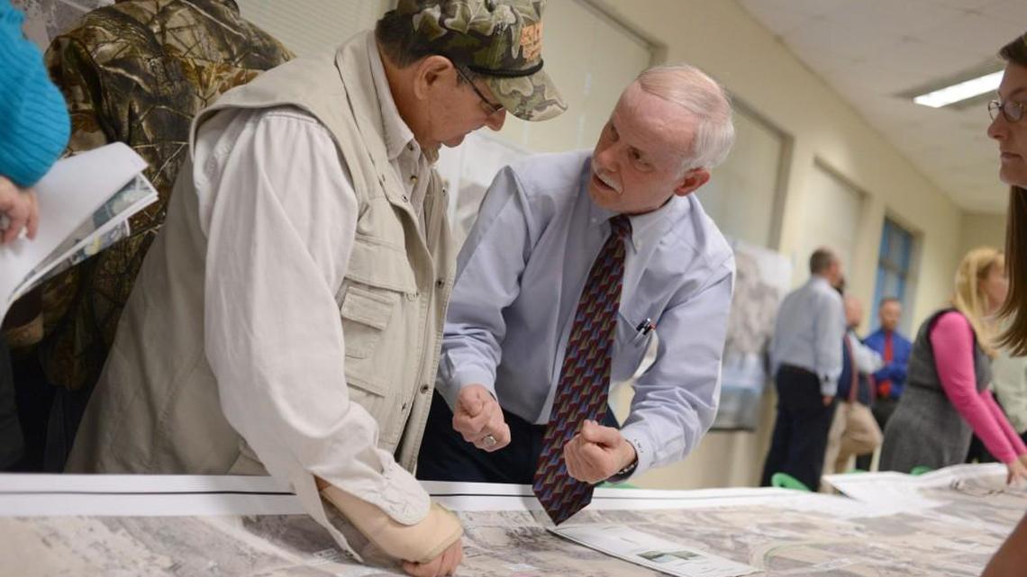 Wilson’s Mills Councilman Kenneth Jones, left, talks to DOT representative Lloyd Johnston about how the various U.S. 70 options would affect his land.