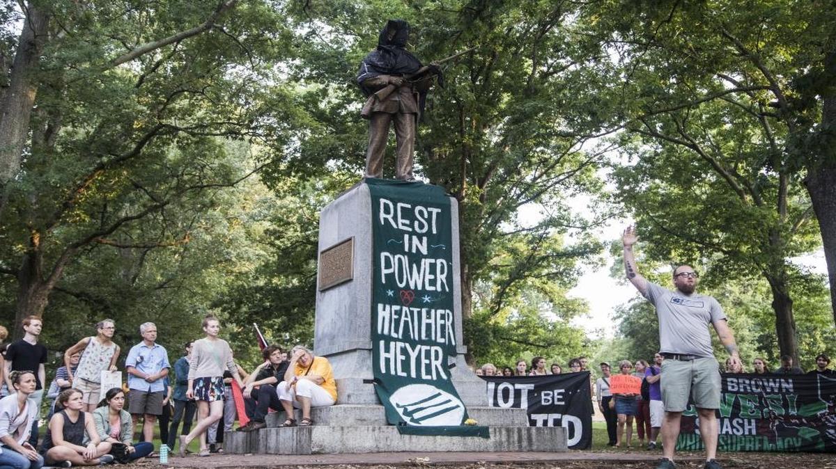 The ‘Silent Sam’ statue, a memorial to Confederate soldiers who attended UNC Chapel Hill, was covered in black cloth as few hundred demonstrators gathered at the statue on Aug. 13 after violent clashes between white supremacists and counterprotesters in Charlottesville, Va. turned deadly.