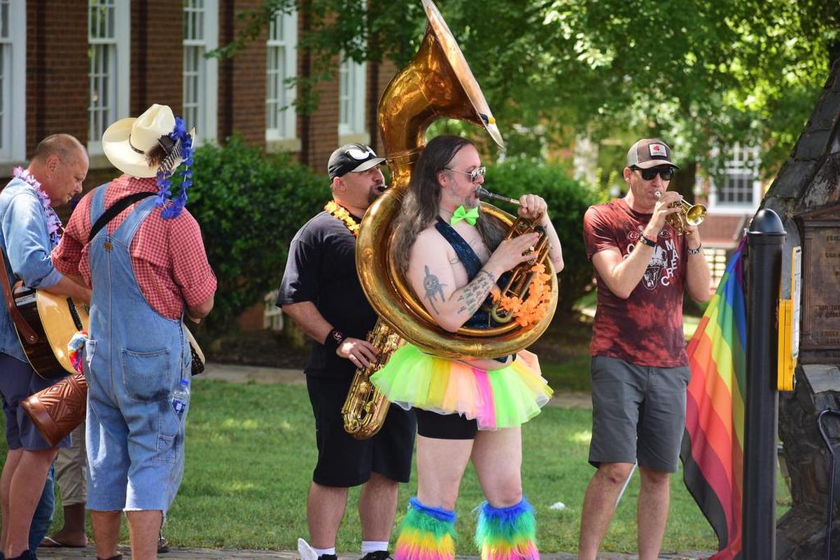 Jeremy Boomhower (center) and members of the Boom Unit Brass Band decided they would “bring some joy” to a rally in downtown Hillsborough on Aug. 3 in support of Matthew’s Chocolates owner Matthew Shepherd.