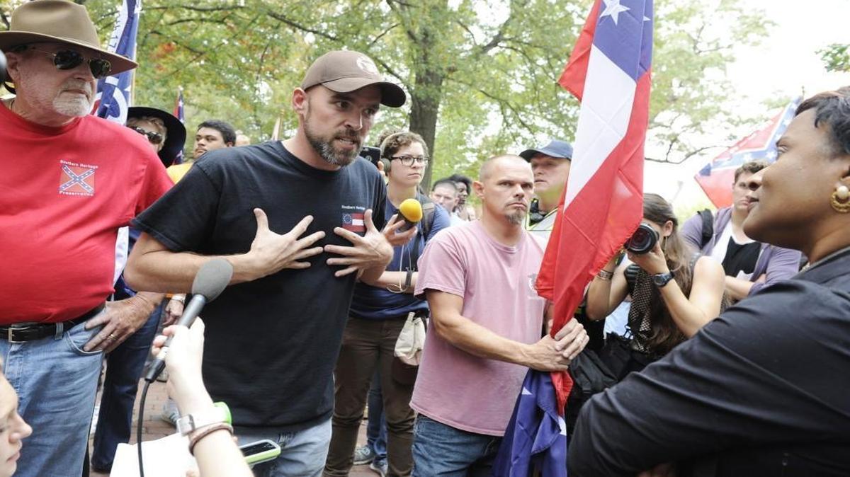 Organizer Gary Williamson, second from left, speaks with a counter protestor who declined to give her name during a rally in support of the confederate soldier monument "Silent Sam" on UNC campus in Chapel Hill, N.C. on Sunday, October 25, 2015. The rally was held by Alamance County Taking Back Alamance County.