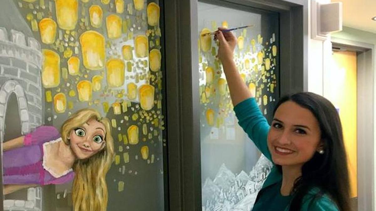 Rachel Howard is painting windows at the N.C. Children’s Hospital with cartoon characters, winter scenes and sights such as UNC’s Old Well.