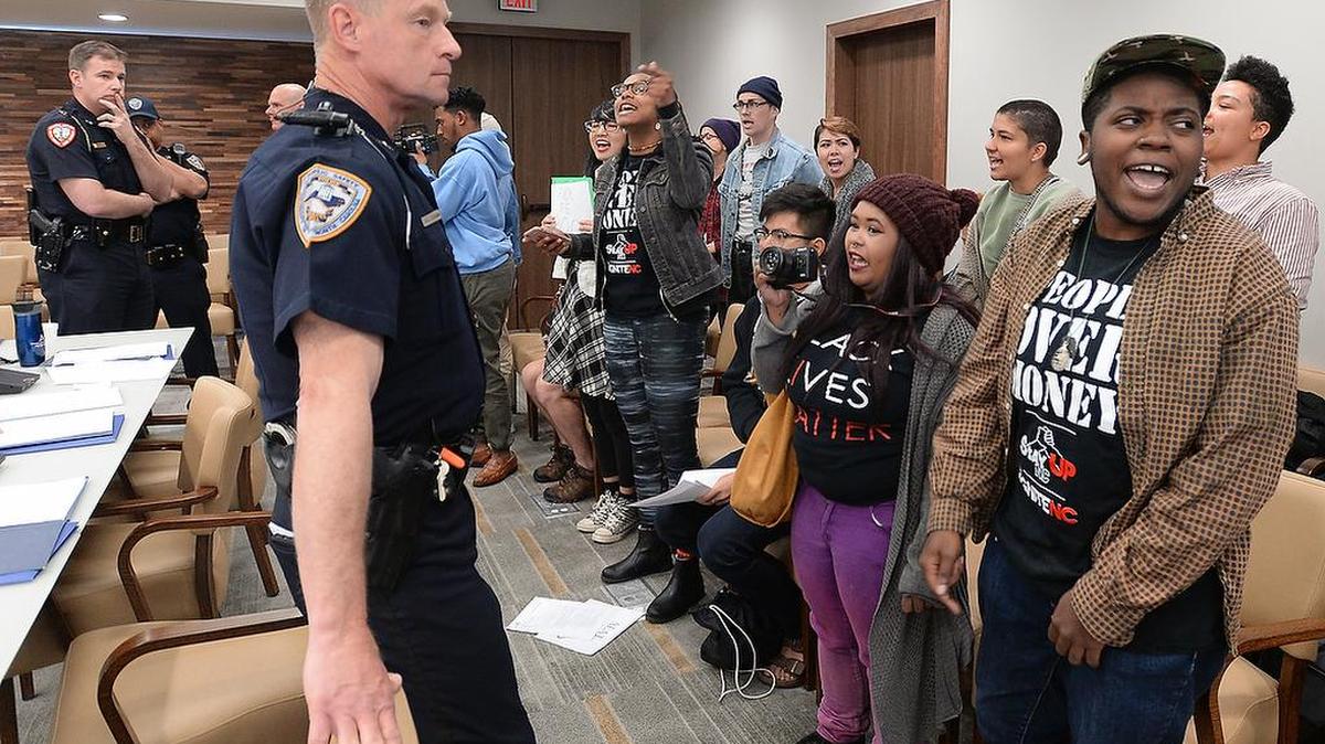 Police ready to escort student protesters out of the UNC Board of Governors meeting in Chapel Hill on April 15, 2016. The protesters left the room after it was cleared and when they were threatened with arrest.
