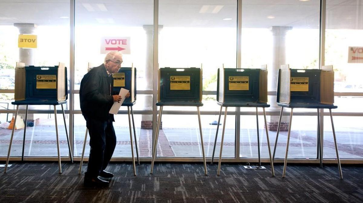 Taking a break as a precinct volunteer at Cary Academy, Raymond Woody, 81, casts his vote, the 28th of the morning at nearly 11am. "I have to do something to get my blood flowing," he says referring to the low voter-turnout. The morning proved to be very slow for polling locations in Cary, N.C. on Tuesday, October 6, 2015 for local, municipal elections.