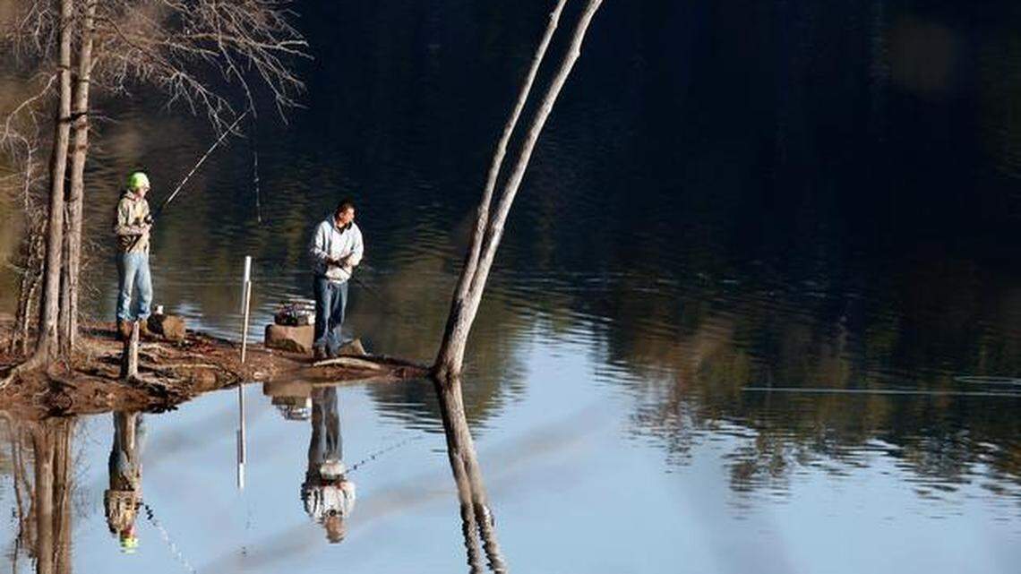 
Friends Kelly Barberee, left, and James Edgerton had the New Year's Day fishing all to themselves at 9 a.m. on January 1, 2015 at the Bells Church fishing area on Jordan Lake in Chatham County.

