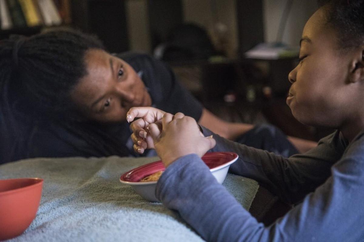 Vanessa Bates talks with her 8-year-old daughter Audrey Hatcher at Bates's mother's home in Durham. Homeless and without a car, Bates has struggled to find steady employment and sleeps on the couches of family and friends. Bates says she usually waits until he children are done eating before she eats a meal, making certain her children have enough to eat.