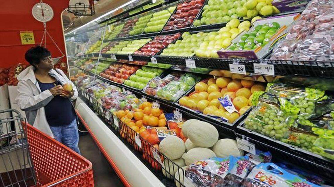 
Customer Pearline Johnson checks out all the colorful fresh fruits and vegetables at the new Save-A-Lot grocery store that opened Wednesday in a shopping center on Martin Luther King Blvd. at the intersection with Raleigh Blvd. It brings fresh, healthy food to a so-called "food desert". The store employs about 27 people. They say many were hired from the local neighborhoods.
