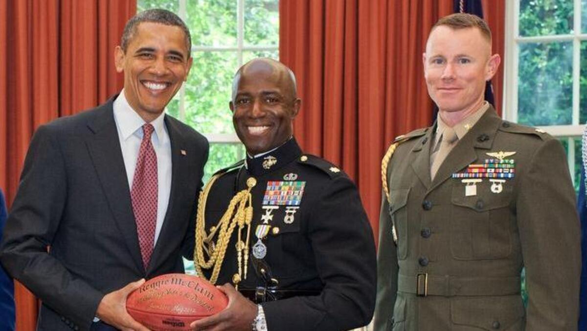 President Barack Obama participates in an end-of tour award presentation to military aide Ma. Reggie McClam in the Oval Office on May 25, 2012. Lee Meyer, right, succeeded McClam in the role. McClam and Meyer are both graduates of Garner High School.