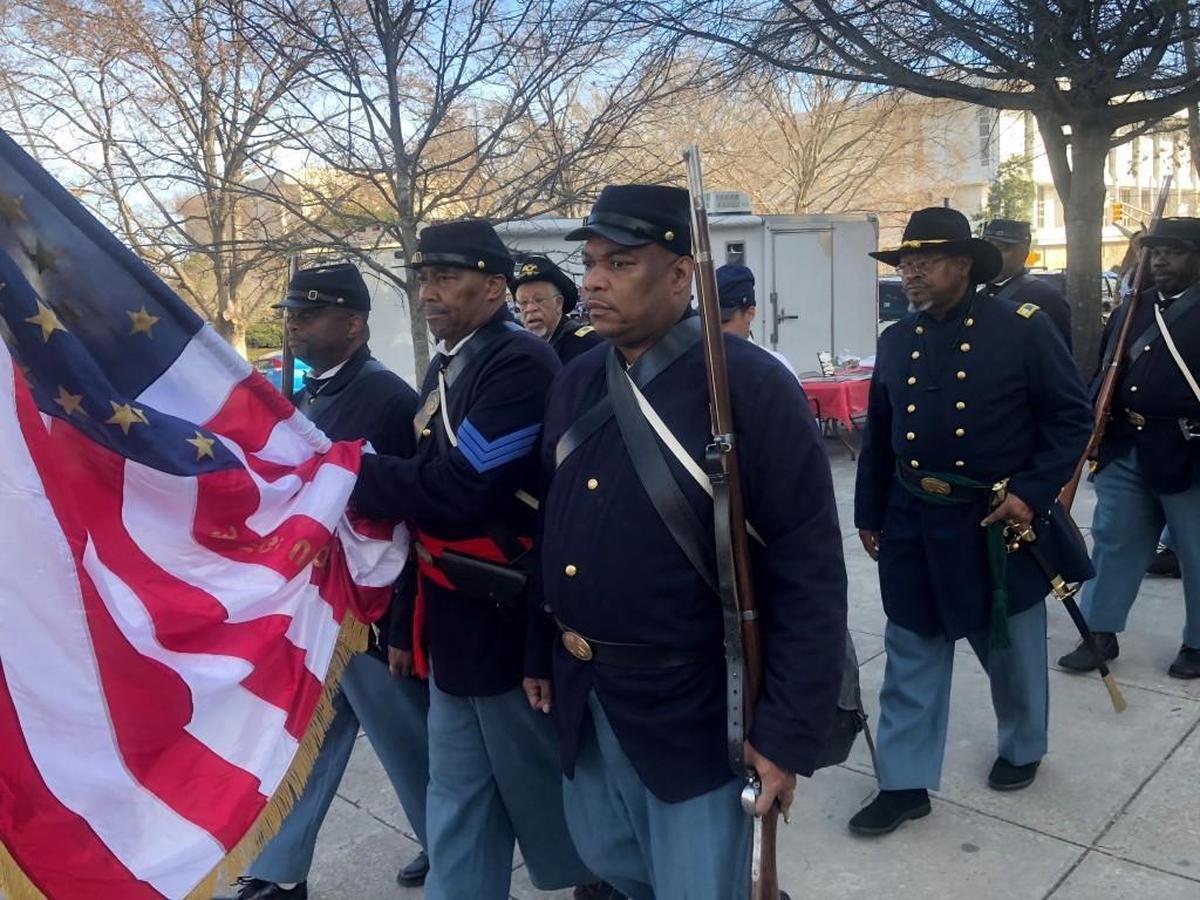 Members of different U.S. Colored Troops re-enactment groups, led in front by color guard of David Theroith (left), Marshall Williams (center) and Julian Tripp (right), march to the N.C. Museum of History in Raleigh for the 17th Annual African American Cultural Celebration on Saturday, Jan. 27, 2018.