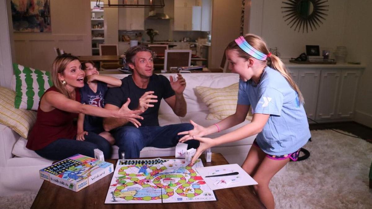 The Holderness family plays Family Showdown, a game they created, at home in Raleigh.