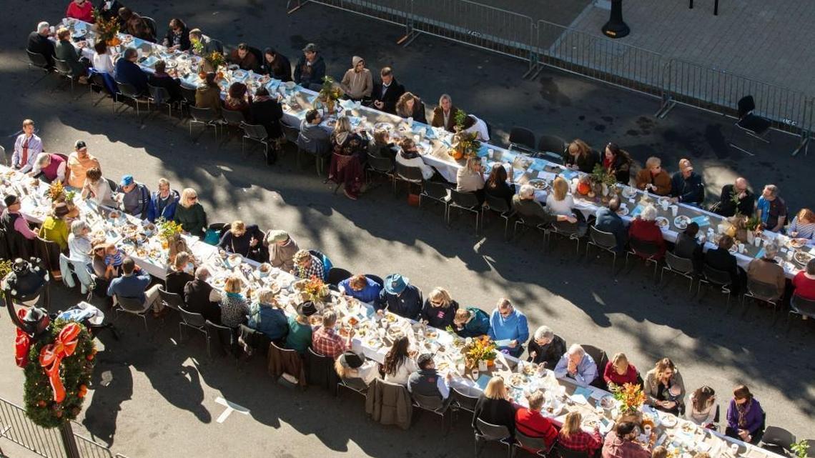 People gather for Sunday Supper on Fayetteville Street, an event benefiting survivors of flooding in eastern North Carolina, in Raleigh, N.C. on Sunday, Nov. 13, 2016.
