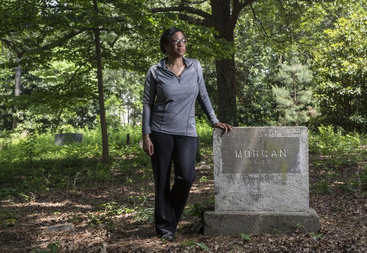 Sabrina Goode leads Friends of Oberlin Village, which works to share the history of the community founded by freed slaves. She stands at her family’s burial plot at the Oberlin Cemetery near Cameron Village in this 2016 photo.