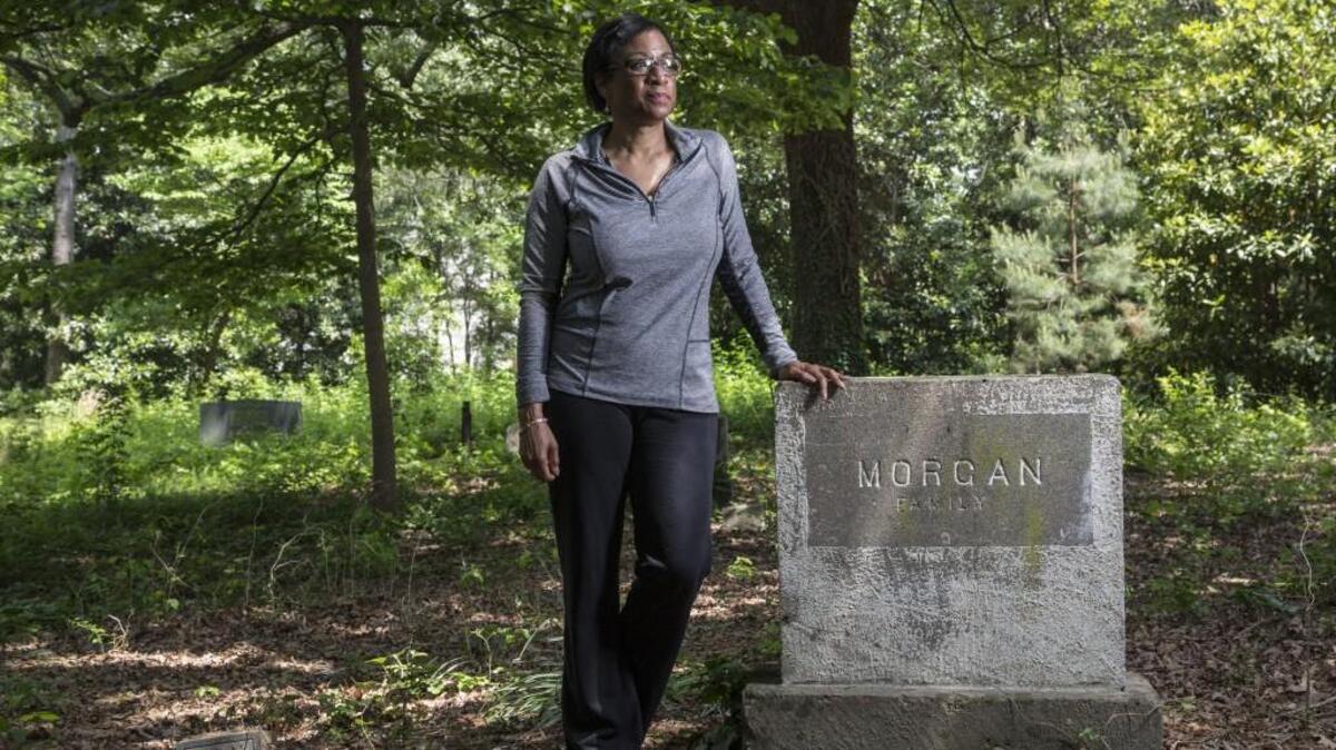 Sabrina Goode leads Friends of Oberlin Village, which works to share the history of the community founded by freed slaves. She stands at her family’s burial plot at the Oberlin Cemetery near Cameron Village in this 2016 photo.
