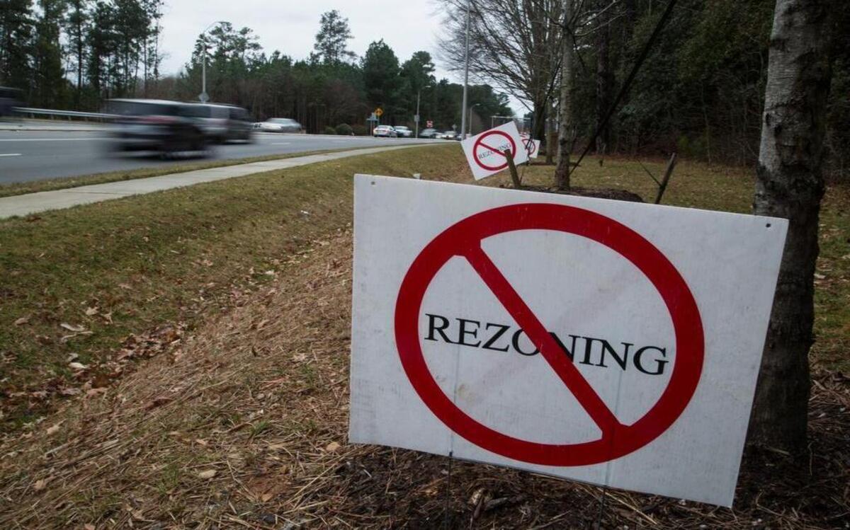 
Rezoning opposition signs line a section of Falls of the Neuse Road on Tuesday, January 10, 2015 in North Raleigh. On Monday, May 11, 2015, the developer dropped plans to build the long-debated Publix grocery store proposed for the intersection of Dunn Road and Falls of Neuse Road.
