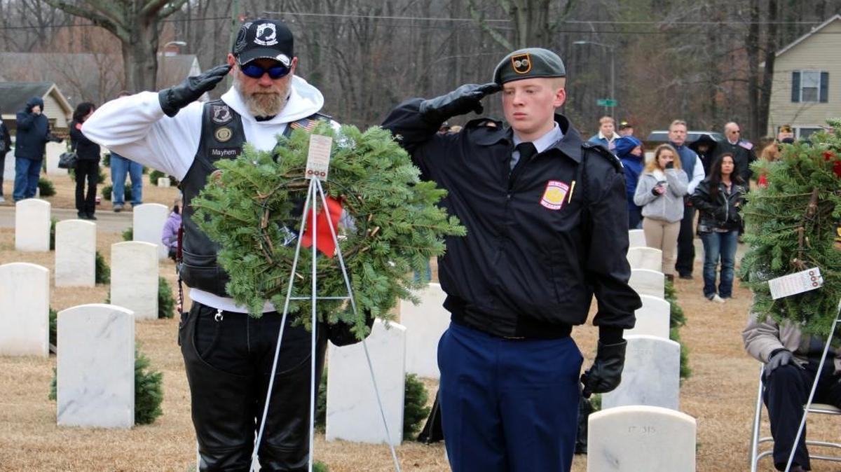 Eric Ellerman, left, of the American Legion Riders Post 436 in Angier and Cadet 1st Lt. Sean Johnson, a member of the Cleveland High School JRTOC, lay a wreath in honor of prisoners of war and soldiers missing in action.
