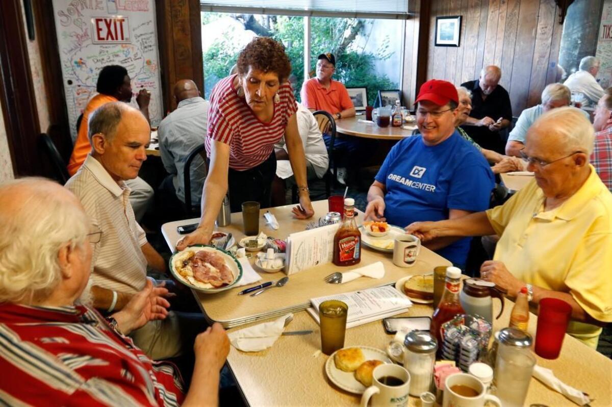 Finch's restaurant server Ann Mosley, center, serves up breakfasts to her regular men’s' Bible study group in 2016.