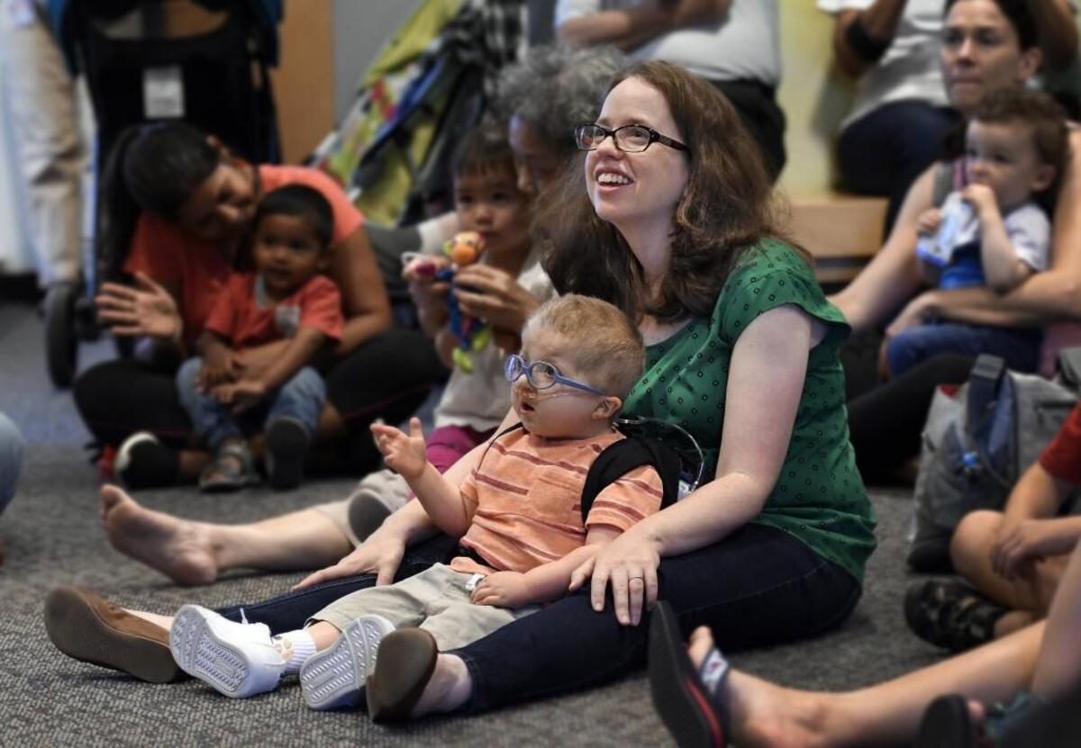 Tommy Yellin, 5, is mesmerized by librarian Keith Hayes as he sits with his mother, Lori Palen, during Toddler Storytime at the West Regional Library in Cary. Tommy, the son of Lori Palen and Wes Yellin, requires a feeding tube, oxygen tank with concentrator, surgeries, costly medications and an in-home nurse. Tommy is one of 2,300 children in North Carolina whose medical costs are covered through a Medicaid program for the medically fragile. Parents of these children worry that Medicaid cuts in the U.S. Senate’s proposed ACA repeal could cause state officials to cut funding for the program.