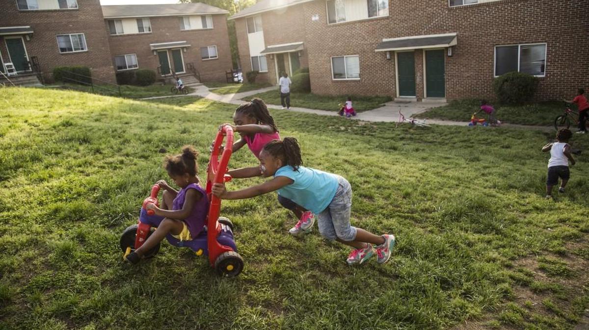 Aniyah Ferguson, 4, is pushed by Aaliyah Whitley, 6, and Oriana Whitley, 7, foreground, on Tuesday, April 21, 2015, at the Raleigh North Apartments. A Denver-based firm has purchased Raleigh North and nearby Millbank Court apartments and plan to rehabilitate the complexes’ 229 townhouse-style apartments.