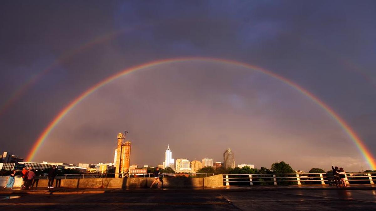 
Following a line of thunderstorms that brought pea-sized hail as it moved through the Triangle on Thursday, April 30, 2015, a double rainbow appeared over downtown Raleigh, drawing crowds to the Boylan Street bridge to get a glimpse.
