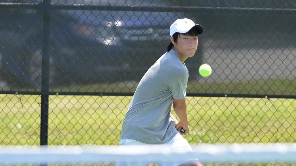 Harrison Tseng of Raleigh Charter High School hits the ball during a tennis match on May 20, 2017.