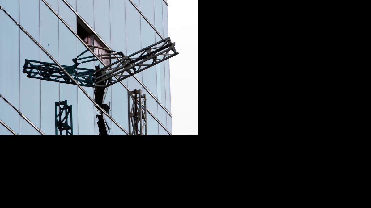 
A section of scaffolding framework protrudes from a shattered window Monday at the scene of a construction accident in downtown Raleigh. Scaffolding holding at least three workers fell and crashed into the Charter Square project, an 11-story building being built on the south end of Fayetteville Street.
