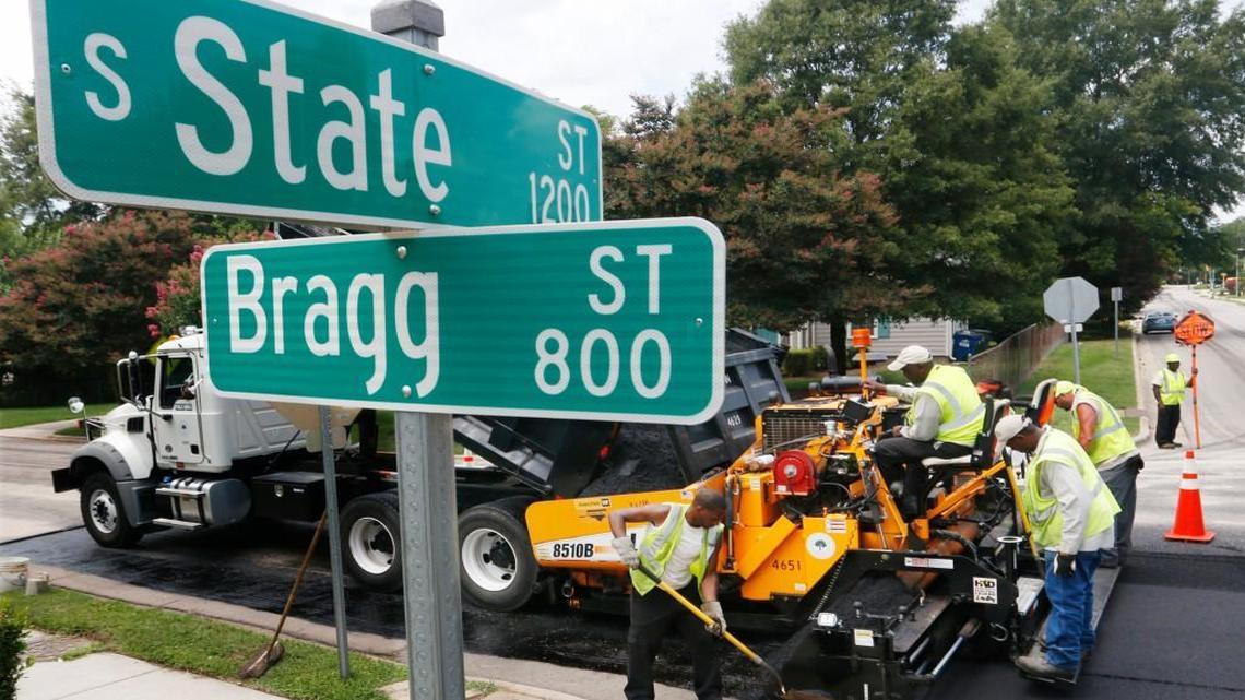 Crews pave the roadway at the corner of South State and Bragg streets in Southeast Raleigh in July 2015.