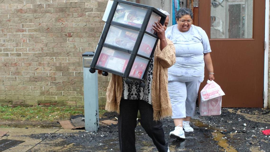 
Members of the Gethsemane Seventh-day Adventist Church in Southeast Raleigh remove items from the church, which was damaged by fire during the early morning hours of Wednesday, June 3, 2015.
