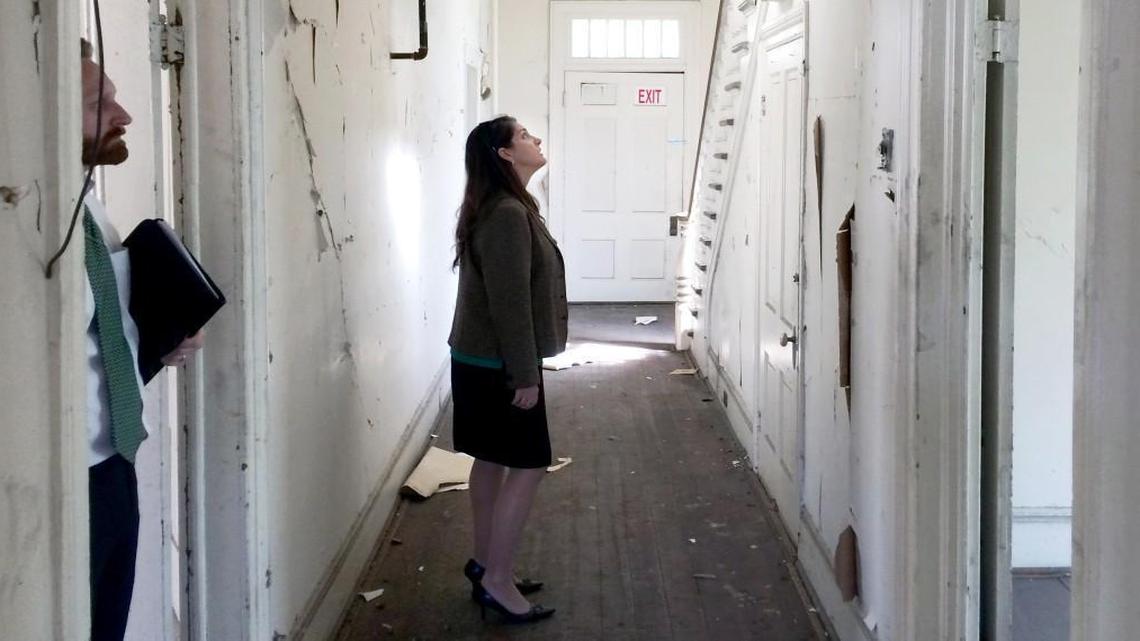 Acting state Secretary of Administration Kathryn Johnston stands in the hallway of the Cambridge House, built about 1902 on North Person Street. The house is under contract to be sold.
