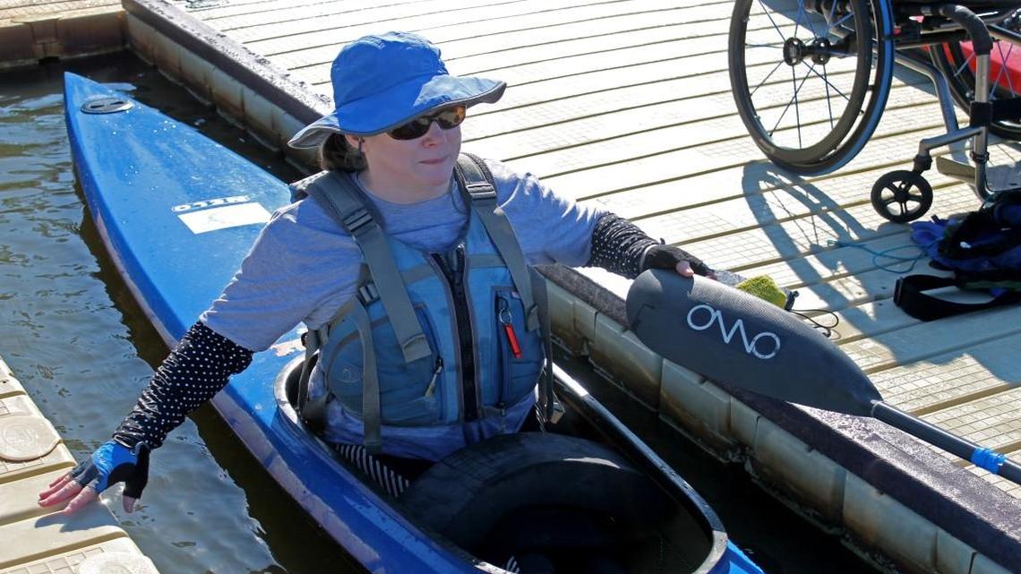 International parakayaker Carol Rogers balances in her racing kayak at the newly constructed accessible dock at Lake Crabtree.