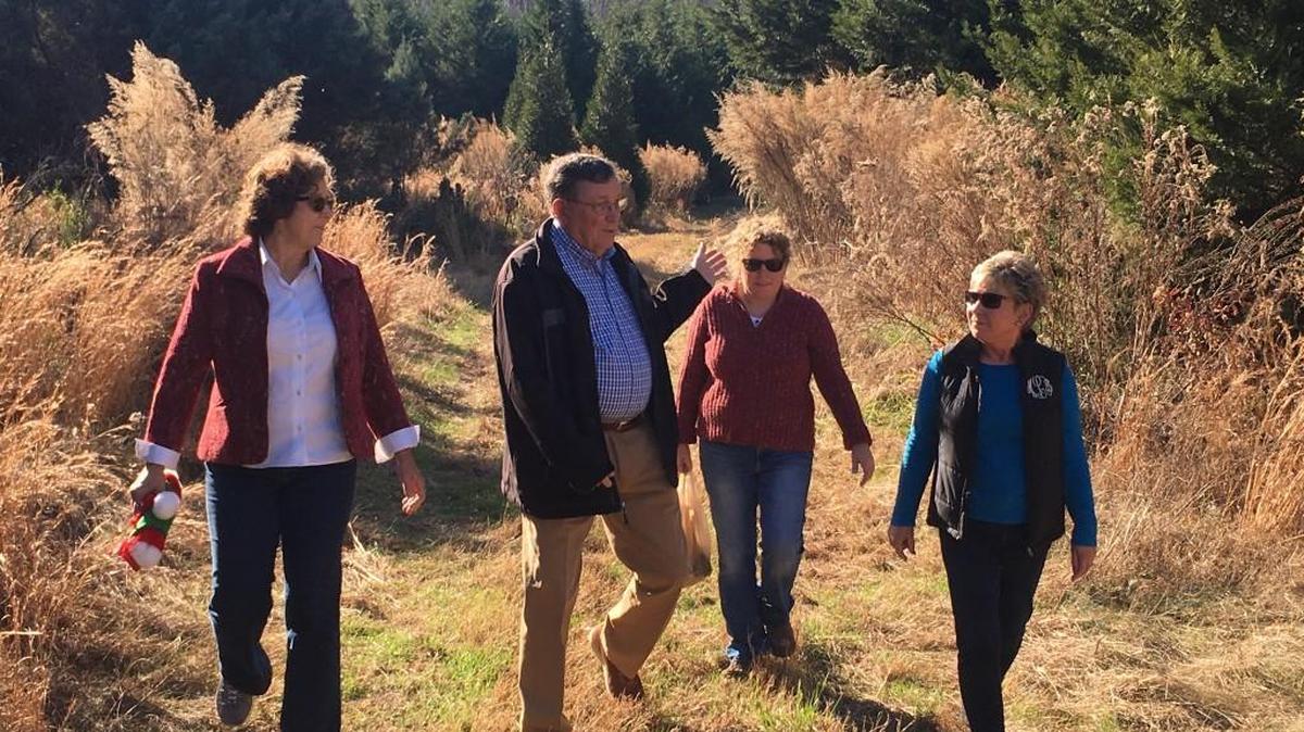 The Triangle Land Conservancy purchased 40 acres of land off Benson Road, including a rare Christmas tree farm, to protect water and wildlife near Lake Benson. From left are Sandy Sweitzer, TLC’s executive director, Robert Liles, Leigh Ann Hammerbacher of the TLC and Martha Liles. The Liles family sold the land for $799,930, about $100,000 less than its appraised value.