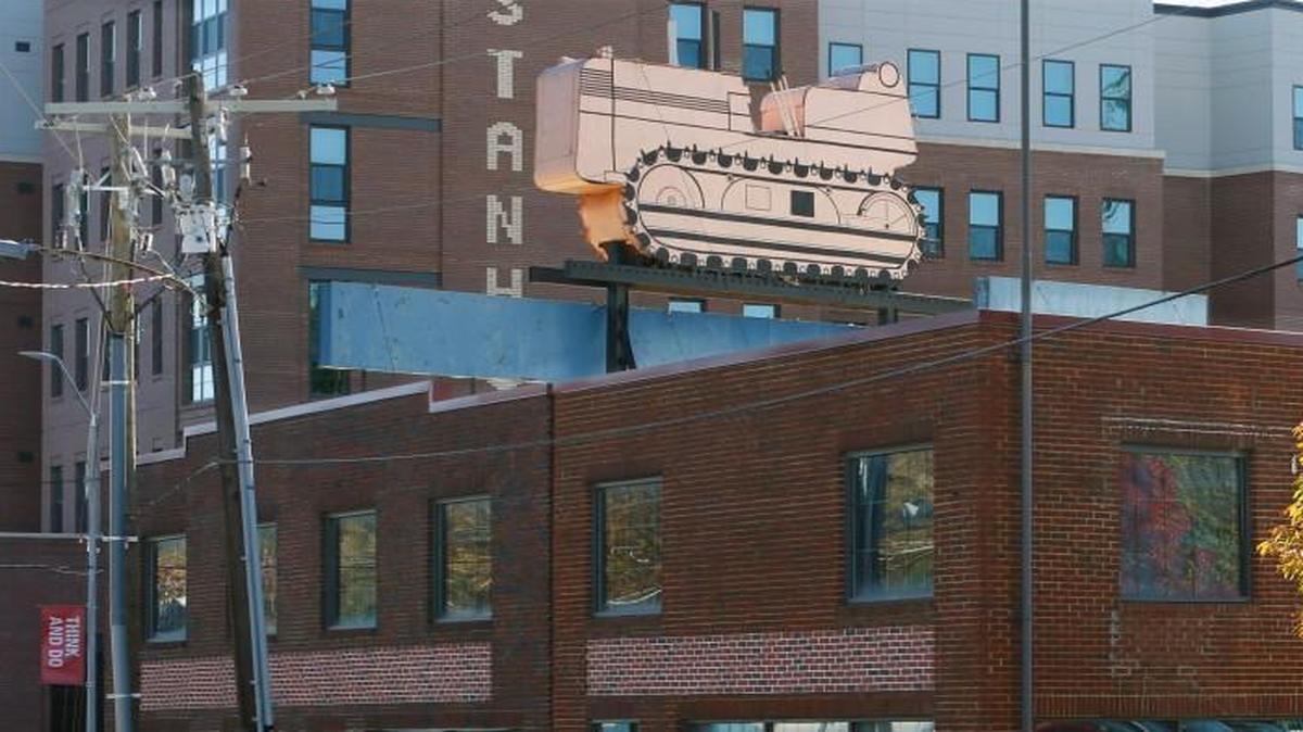 A tractor sign sits on top of the old N.C. Equipment Co. building at 3101 W. Hillsborough St. in Raleigh.