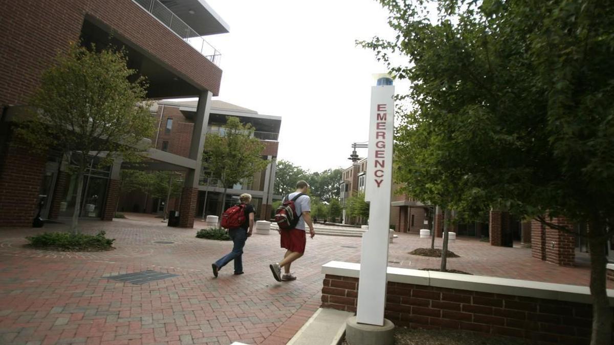 NC State students walk past an emergency phone located in the Wolf Village Dorms in this file photo from 2007.