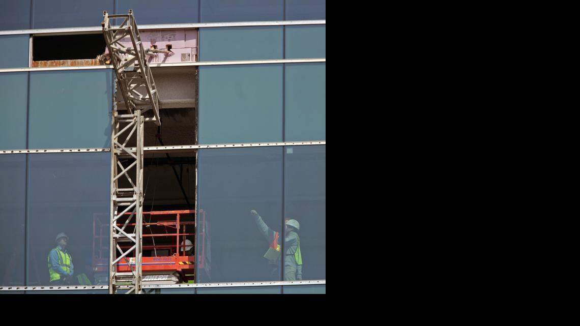 
Inspectors take a closer look Tuesday, from the fifth floor of the Charter Square Building, at the damage done when a scaffolding collapsed on Monday, killing three workers in downtown Raleigh.


