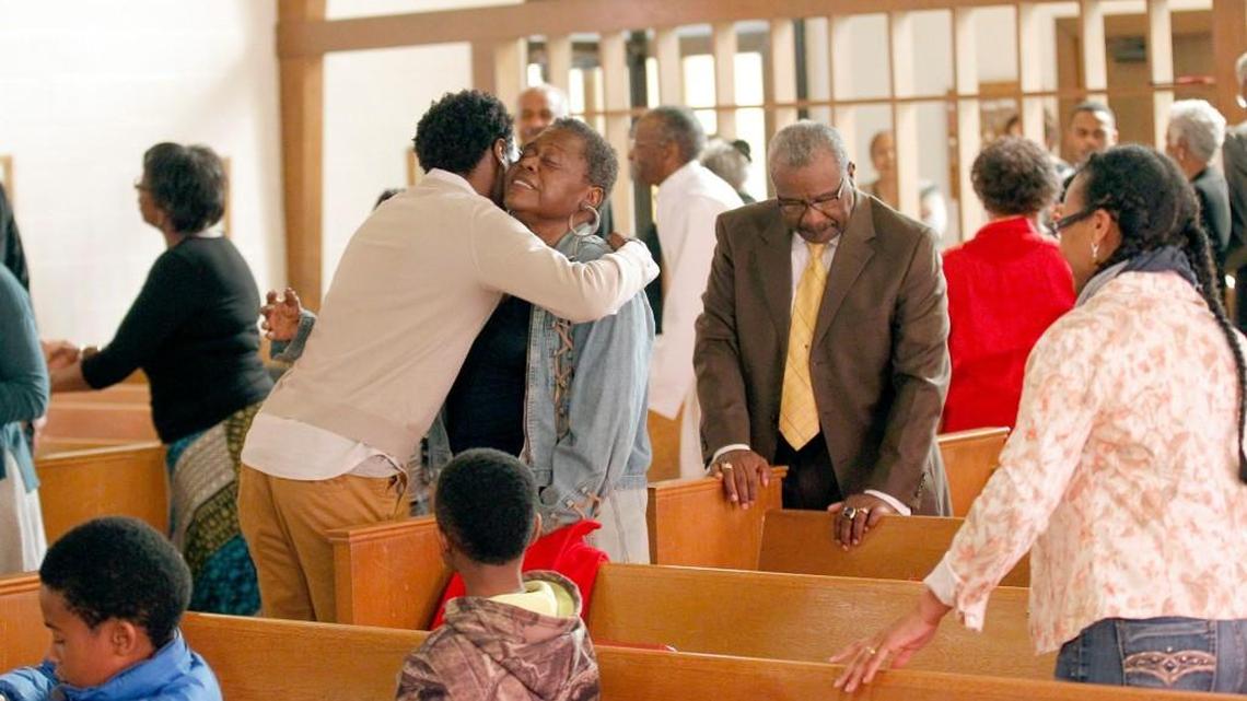 Congregation members greet each other during the peace blessing during the service at St. Ambrose Episcopal Church in Raleigh. The archivist of the Episcopal diocese is wrapping up a yearlong project on historically black episcopal churches in the state, of which St. Ambrose is only one of a couple dozen still active in the state.