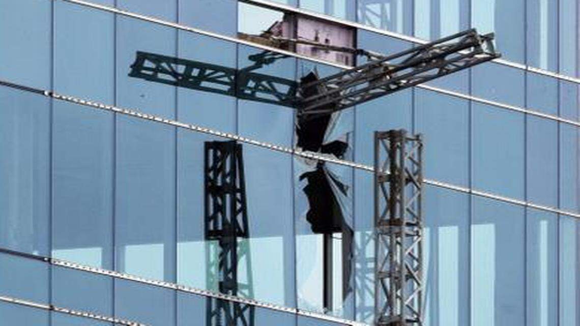 
A broken piece of scaffolding, right, juts from the Charter Square project after a collapse Monday, March 23, that left three workers dead and another seriously injured in downtown Raleigh. 


