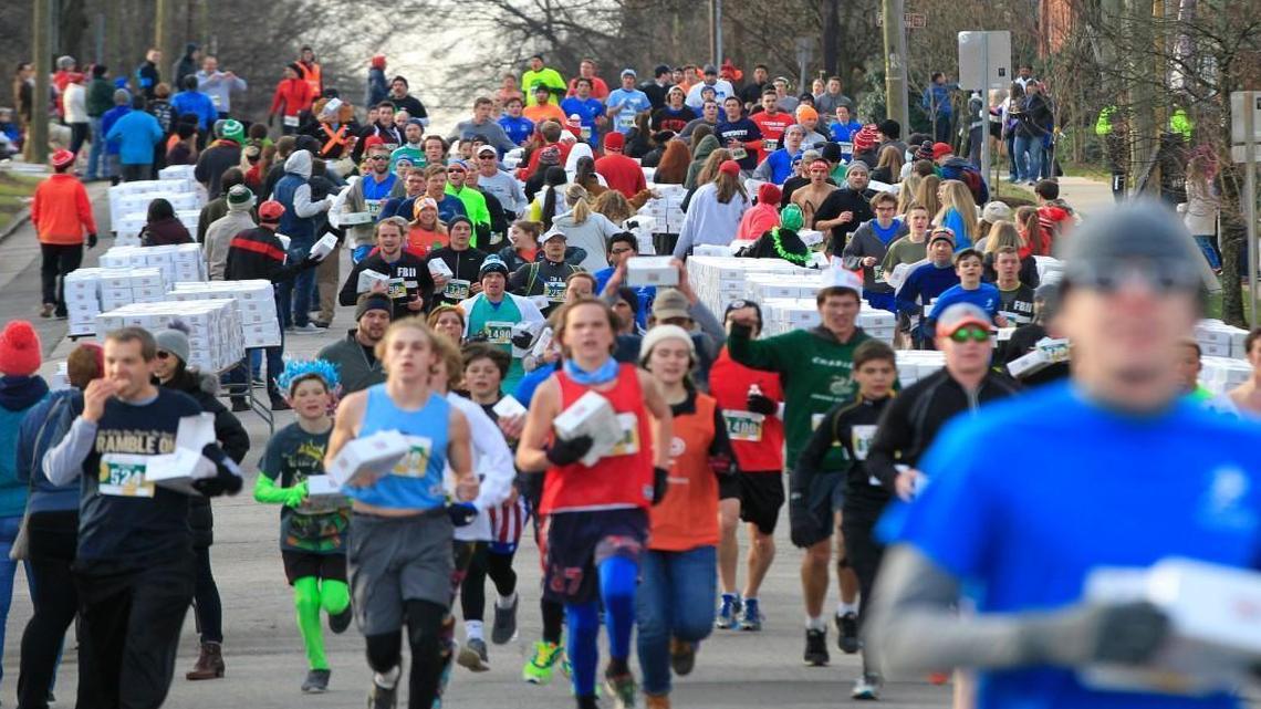 Runners head down North Person Street after picking up their doughnuts during the 12th annual Krispy Kreme Challenge on Saturday.