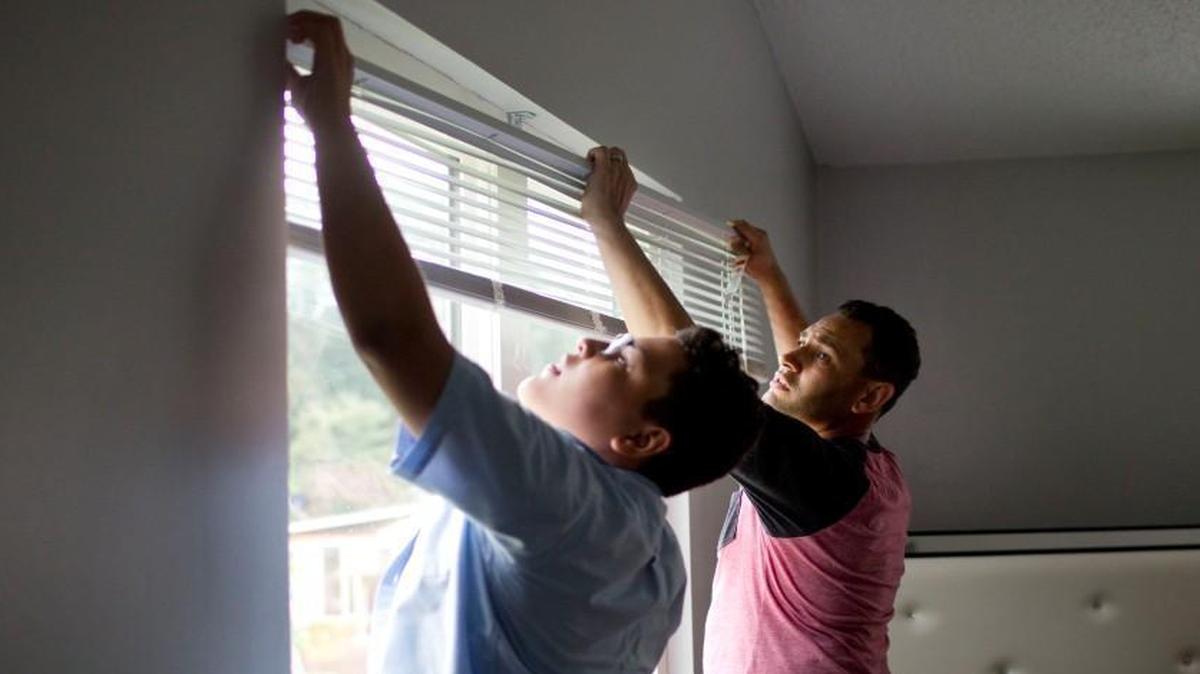Aaron Parker and his son Aaron Parker, 11, work to prepare their home to go on the housing market Wednesday, July 6, 2016 in Raleigh, N.C. Parker recently left his job with the Raleigh Fire Department to take a new job in the fire marshal’s office in Seattle.