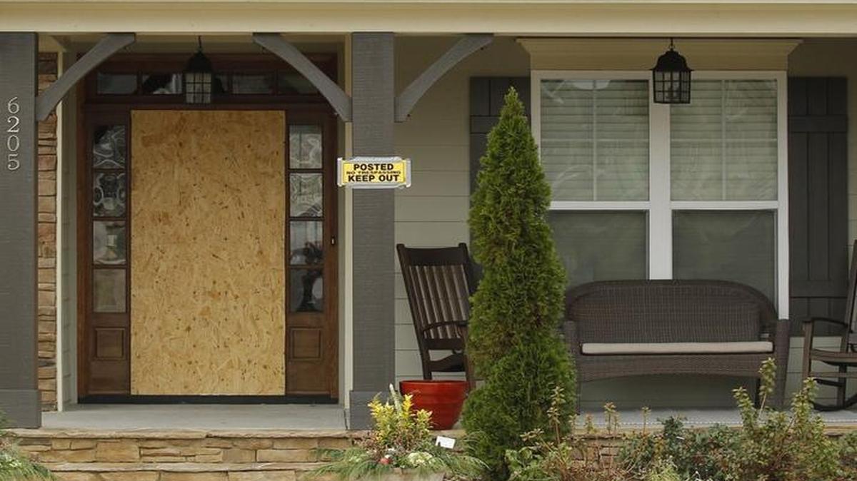 The front door and an upstairs window remains barricaded at the house at 6205 Roles Saddle Drive in Rolesville, NC on Jan. 4, 2016. Kristy Bryan, 39, died in a Dec. 11, 2015 fire inside the two-story house in the Heritage neighborhood. Bryan's 3-year-old son also died in the fire and her other son was injured. Rolesville police have ruled the case a murder-suicide, saying Bryan started the fire in the master bedroom of her two-story home.