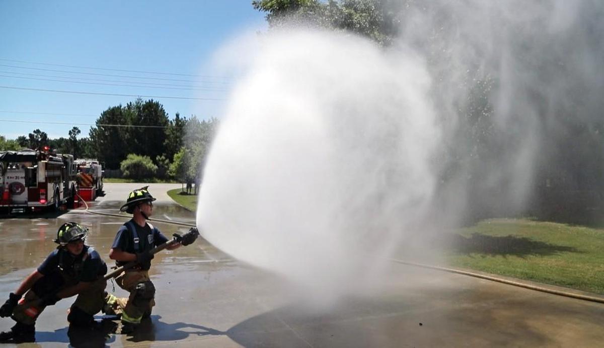 Firefighters Jimmy McDonald, left, and Joseph Williams participate in a training drill at the Bay Leaf fire station on Six Forks Road north of Raleigh on June 26, 2017. The Bay leaf and Stony Hill fire departments are merging July 1. The merged group will be known as the Northern Wake Fire Department.