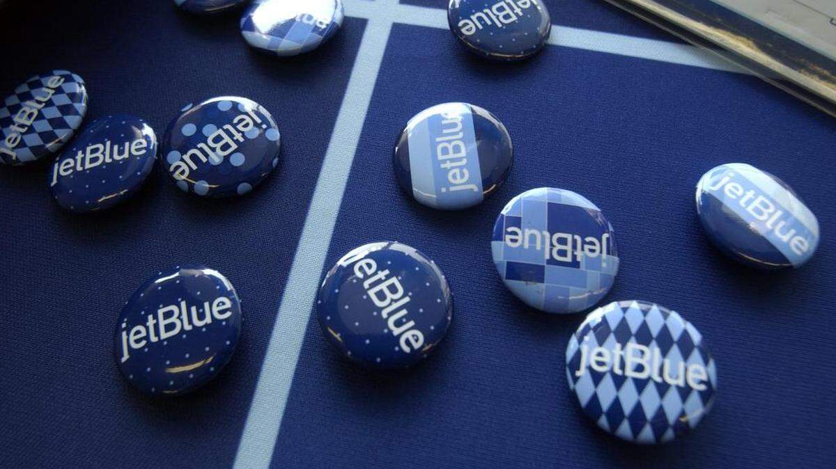 A pile of jetBlue buttons sits on a food table near the departure gate at RDU International Airport as jetBlue service begins at the airport in this July 2, 2006, file photo.