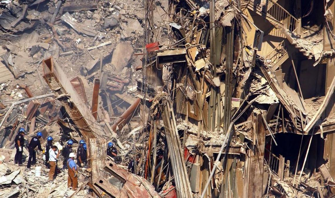 Rescue workers move toward the remains of a stairwell in the wreckage of the World Trade Center north tower in New York, Wednesday, Oct. 3, 2001.