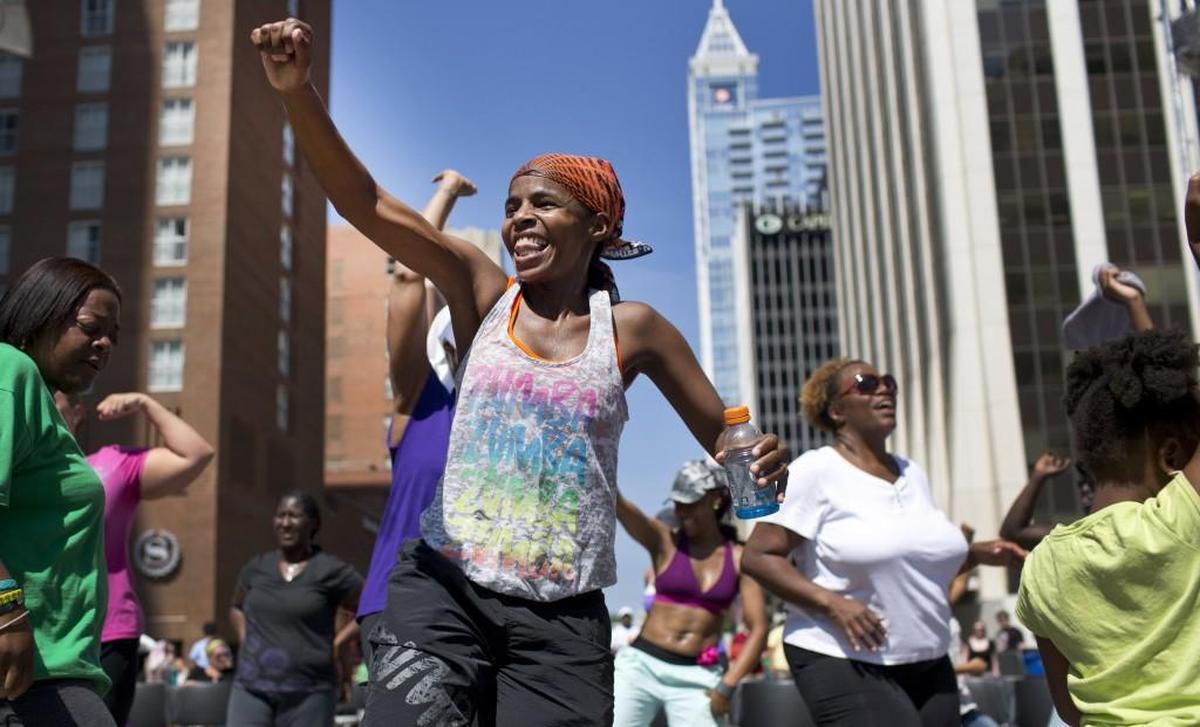 Tanessa Barlow, a Zumba instructor, dances in front of the main stage at the SPARKcon Zumba Party on Sept. 15, 2013, in downtown Raleigh.