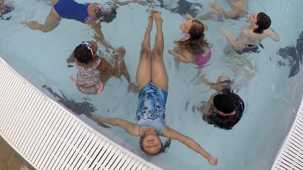 A young swimmer floats on her back at Optimist Pool in Raleigh in June. Wake County officials are urging public pools in the county to treat their water with extra high levels of chlorine to combat a gastro-intestinal disease caused by micro-parasites.