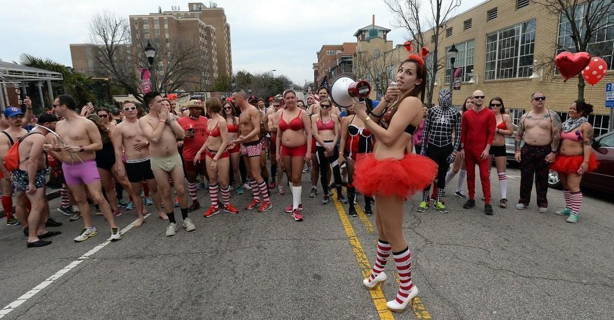 Race director Jennifer Burnette uses a megaphone to ready racers for the start of the Cupidâs Undie Run in Raleigh, N.C. Saturday, February 20, 2016. The charity event raises money for the Childrenâs Tumor Foundation. CTF is the worldâs largest non-government organization dedicated to ending Neurofibromatosis through research.